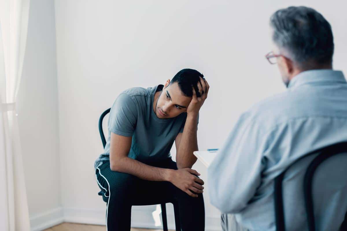 lagunashoresrecovery How Long Does Crystal Meth Stay in Your System photo of Depressed teenager looking away while talking to his therapist