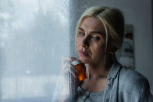 Woman with pill bottle choosing drugs over relationship