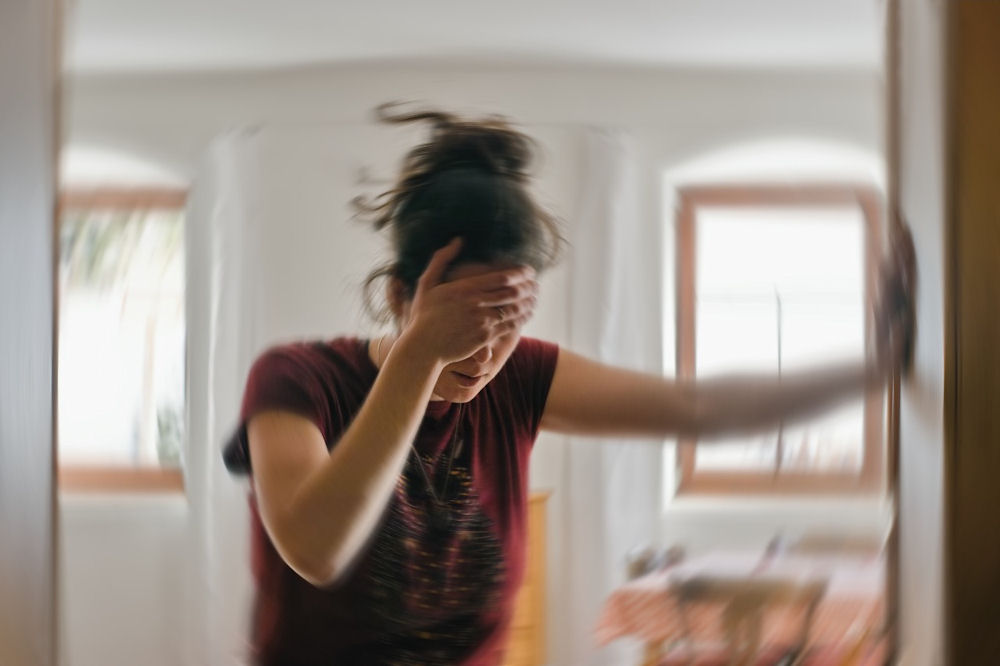 Woman experiencing dizziness and blurred vision from alcohol