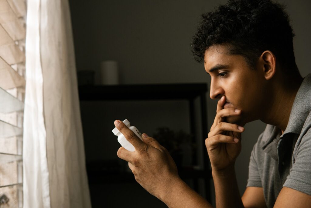 a man holding and staring at a bottle of xanax