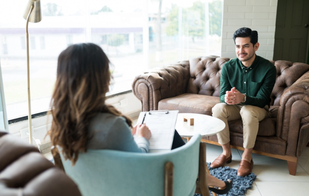 Man and a therapist having a conversation about substance abuse therapy